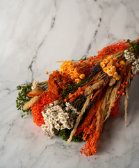 Vertical one-sided dried flower bouquet in orange and red
