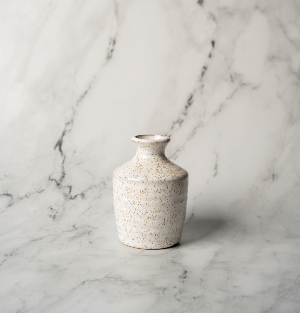 Small cream textured ceramic bud vase