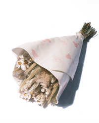 The Prague dried flower bouquet in cream and tan neutrals, wrapped in paper