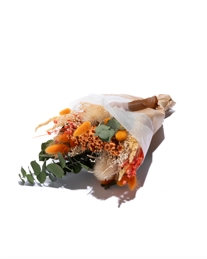 Light Orange Mix dried flower bouquet in orange and peach, wrapped in paper