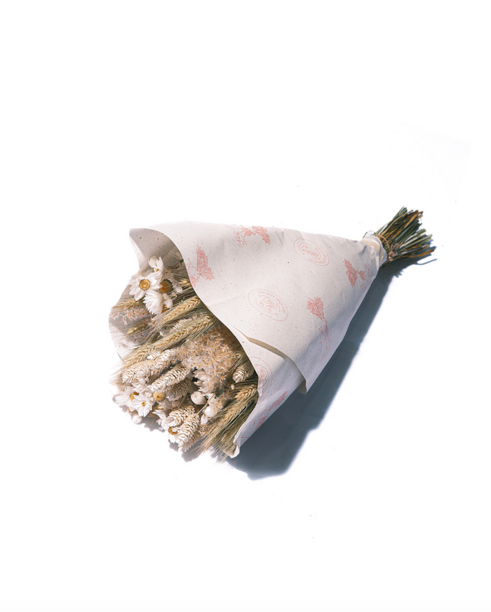 The Prague dried flower bouquet in cream and tan neutrals, wrapped in paper