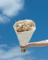 The Prague dried flower bouquet in cream and tan neutrals, wrapped in paper