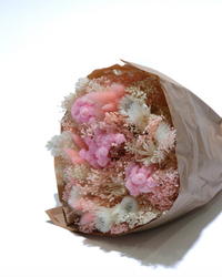 Romantic dried flower bouquet in blush, pink and cream, wrapped in paper