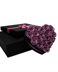 Eighteen lilac preserved roses in a black heart-shaped box