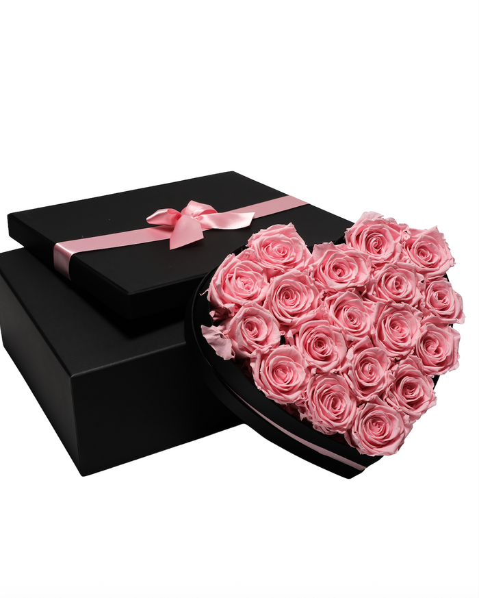 Eighteen baby pink preserved roses in a black heart-shaped box