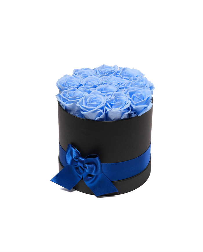 Twelve sky blue preserved roses in a black round hat box