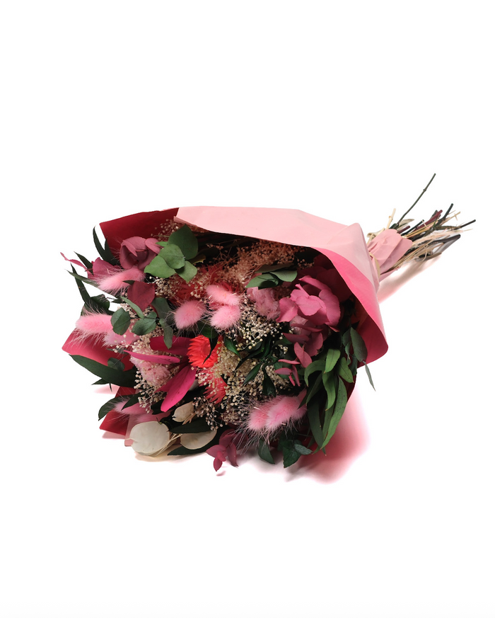 Primavera Pink dried flower bouquet in pink and rose tones, wrapped in paper