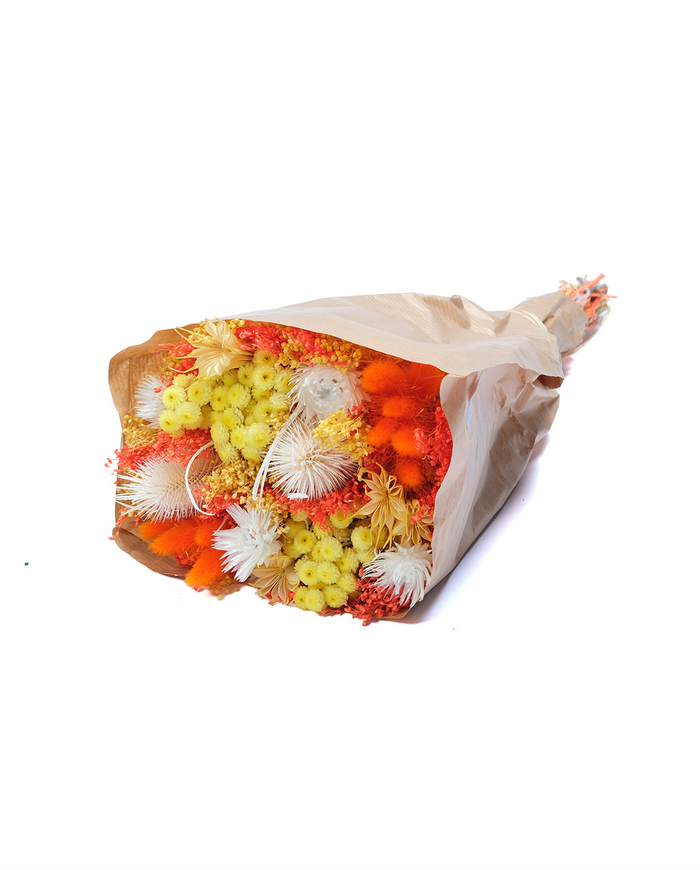Sunset dried flower bouquet in orange, coral and yellow, wrapped in paper